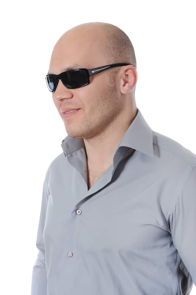 bald man wearing wraparound sunglasses
