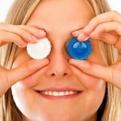 woman covering eyes with contact lens case