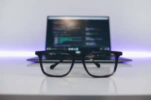 blue light glasses in front of laptop