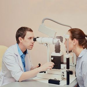 optometrist examining patient's eye