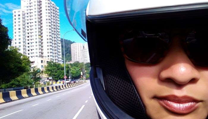 closeup of woman in motorcycle helmet and sunglasses