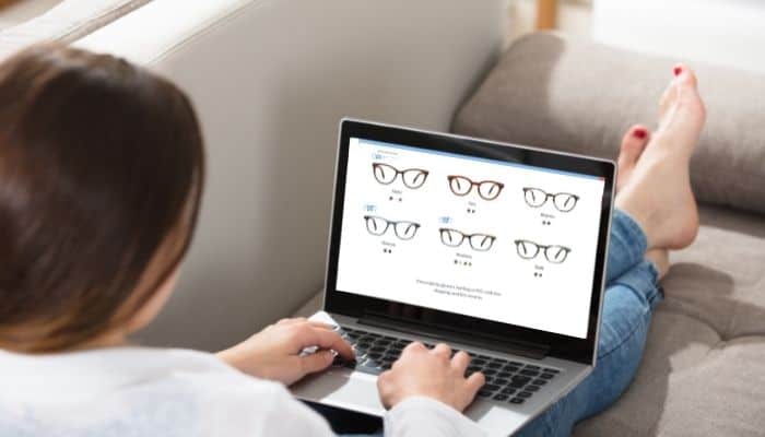 woman shopping for eyeglasses on laptop