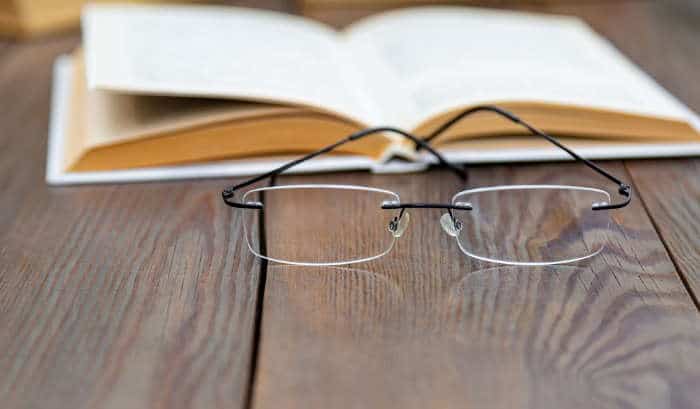 rimless glasses and book