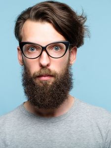 bearded man wearing cat eyeglasses