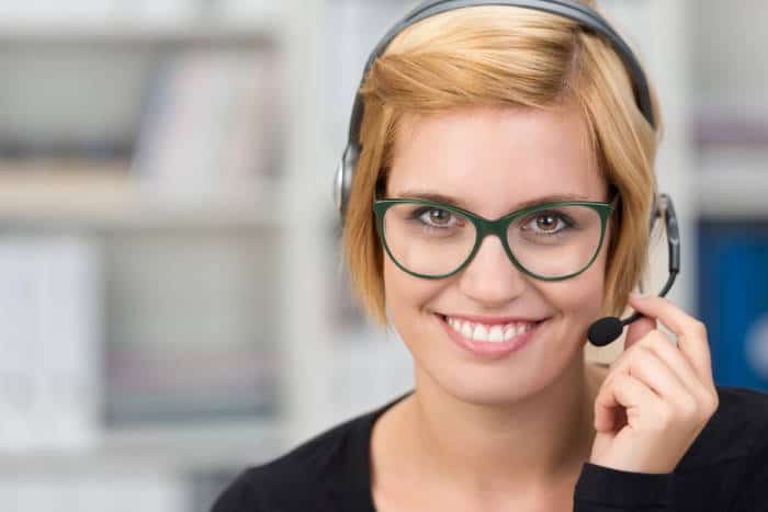 woman in green glasses wearing headset