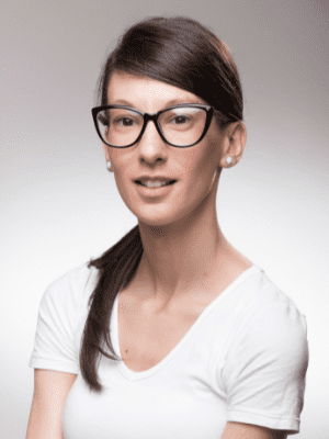 young woman with long face wearing cat eyeglasses