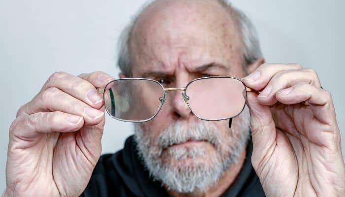 man with scratched eyeglass lenses