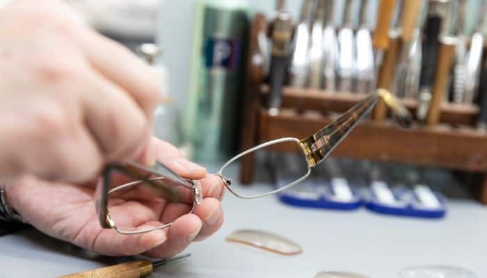 optician working on glasses