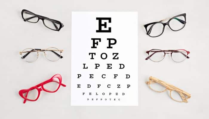 eye chart surrounded by 6 pairs of glasses