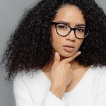 woman in glasses with pensive expression