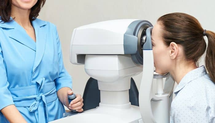 woman getting vision checked with machine