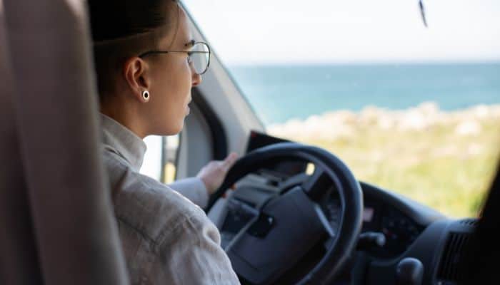woman wearing glasses driving