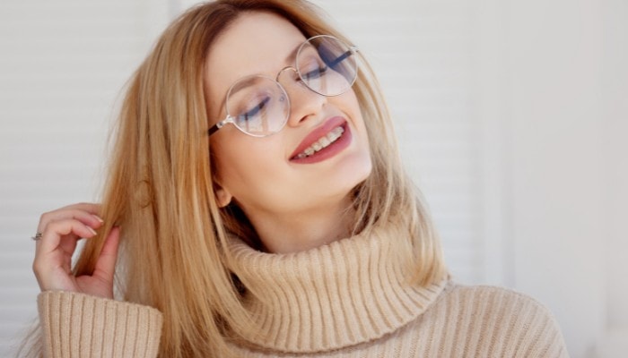 woman wearing oversized round metal glasses