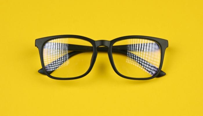square glasses on yellow background